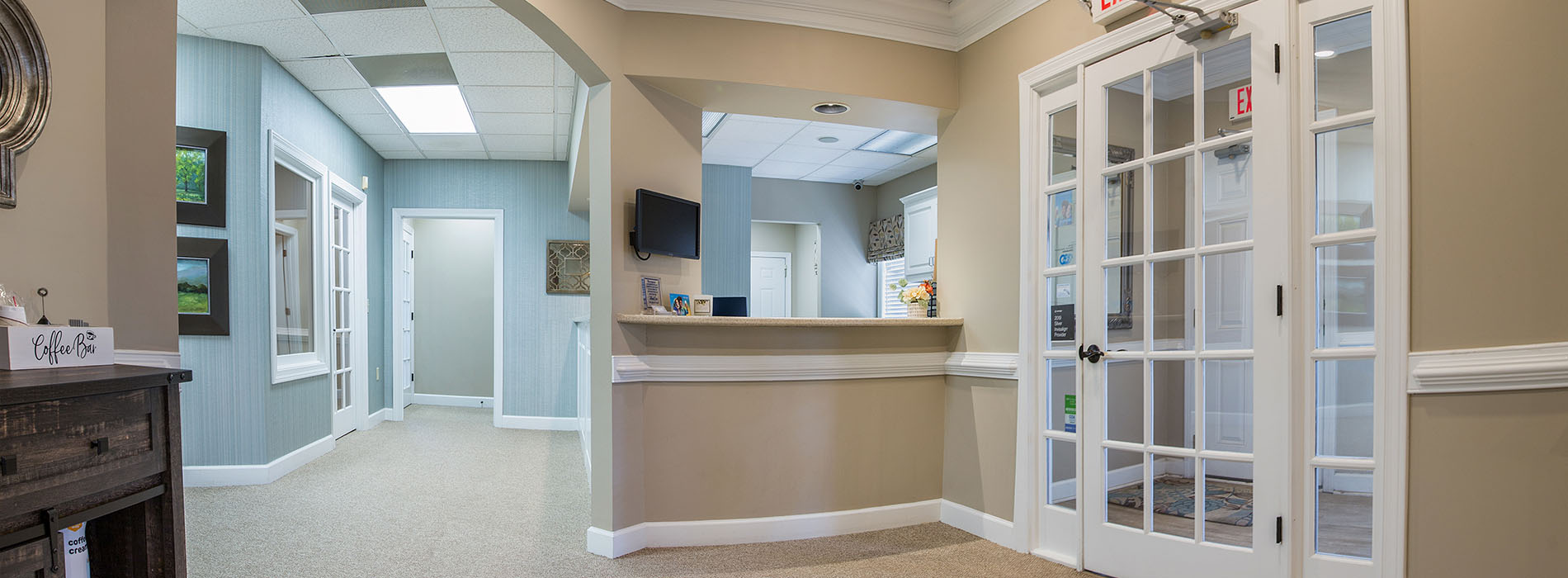 The image is a composite of three photographs displaying an interior space with various elements such as a reception area, a waiting room, and a hallway leading to offices.